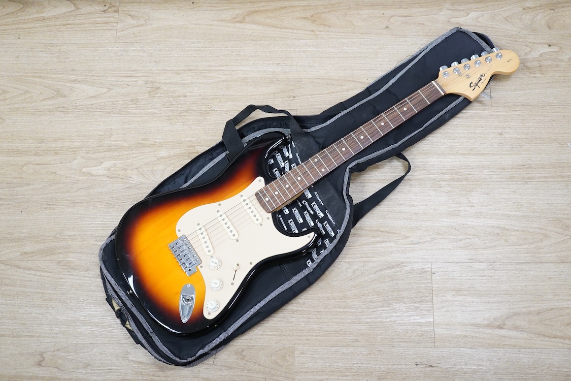 A Fender Squire electric guitar, with a Kinsman soft case, together with a Peavey VYPYR 15W modelling amplifier